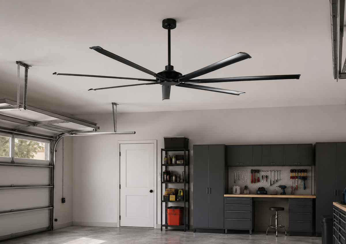 Large black industrial ceiling fan installed in a modern garage workspace.