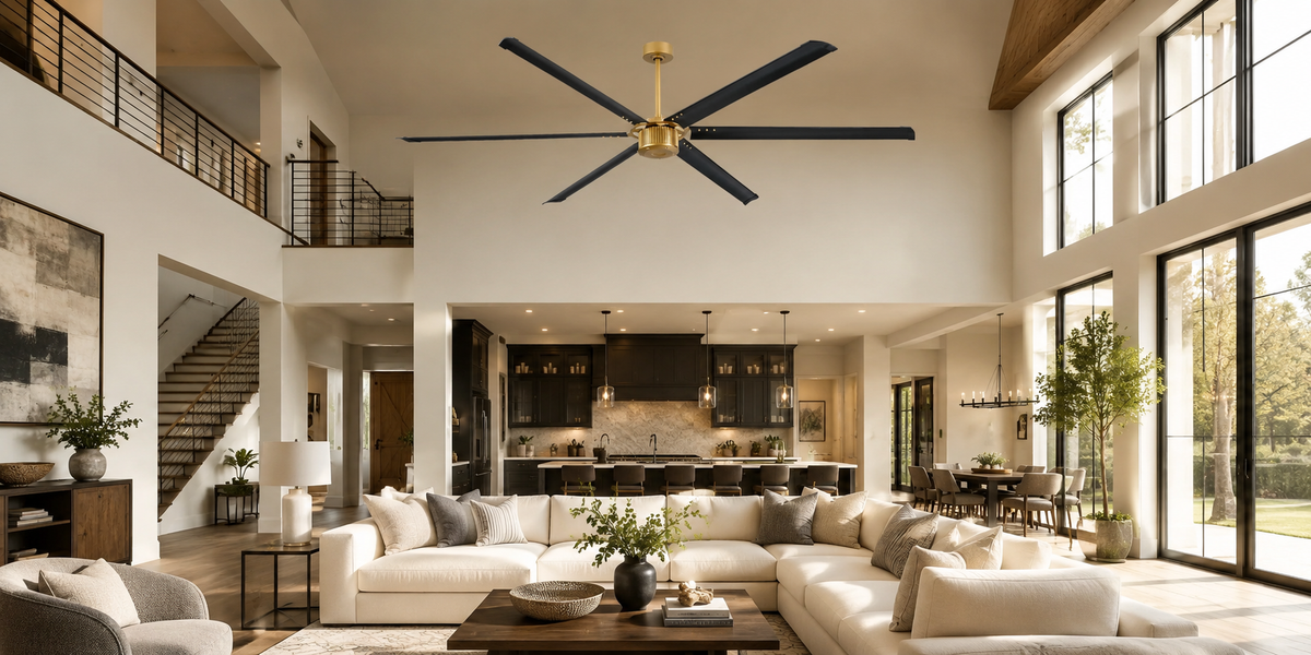 Large black industrial-style ceiling fan in a modern high-ceiling living room.